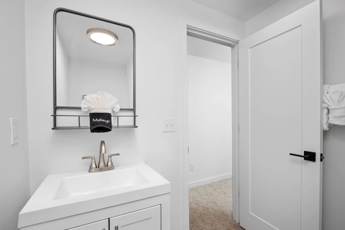A well-lit vanity area with a sink, mirror, and organized makeup station, perfect for personal grooming and getting ready for a day out. The inviting setup emphasizes a sense of intimacy and care in the inn's amenities.